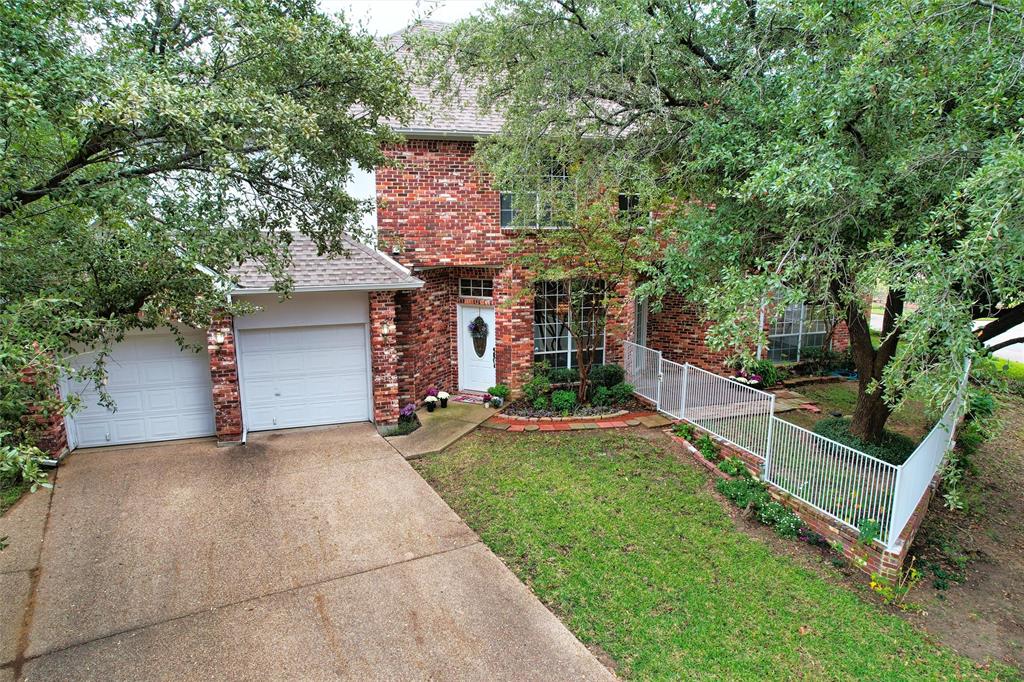 a front view of a house with a yard and a garage