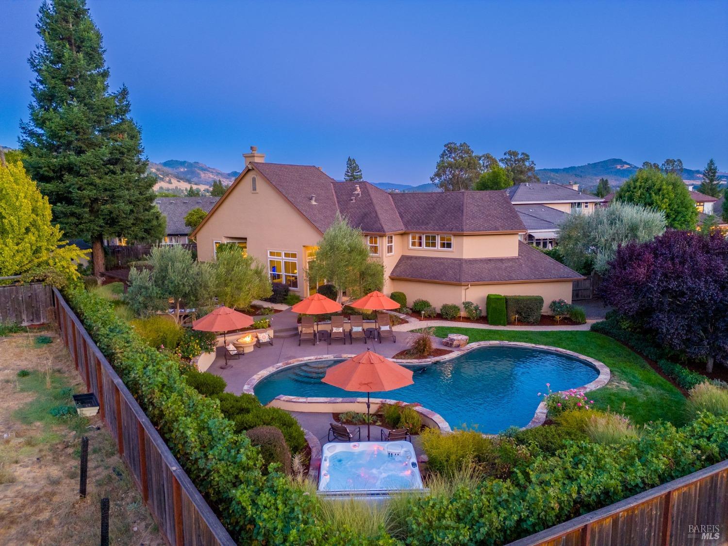 an aerial view of a house with swimming pool outdoor seating and yard