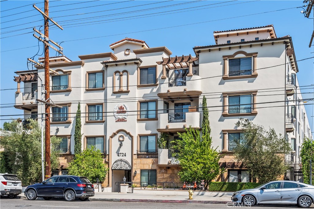 a front view of a residential apartment building with a yard