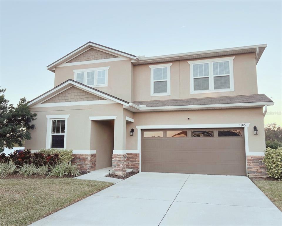 a front view of a house with garage and garage