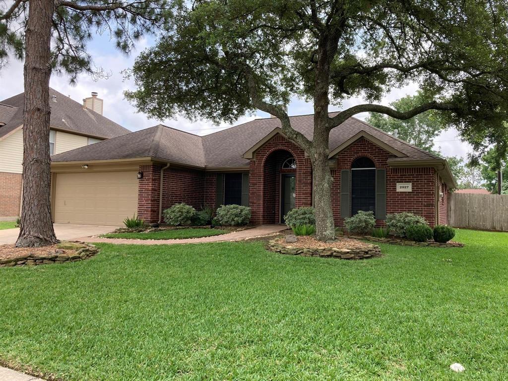 Charming brick home with a spacious two-car garage, nestled in a serene neighborhood. Enjoy the lush, well-maintained lawn and mature trees offering shade and privacy. Perfect for families seeking comfort and tranquility.