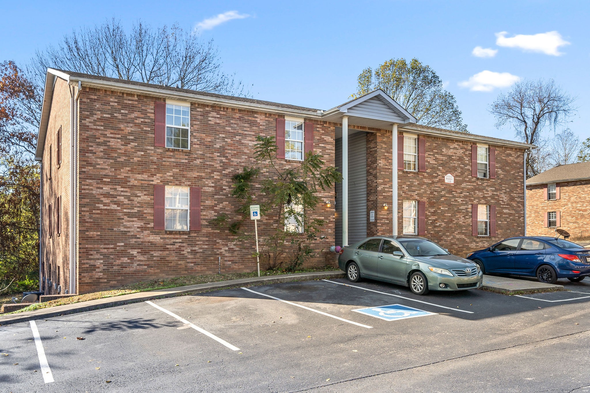 a cars parked in front of a brick house