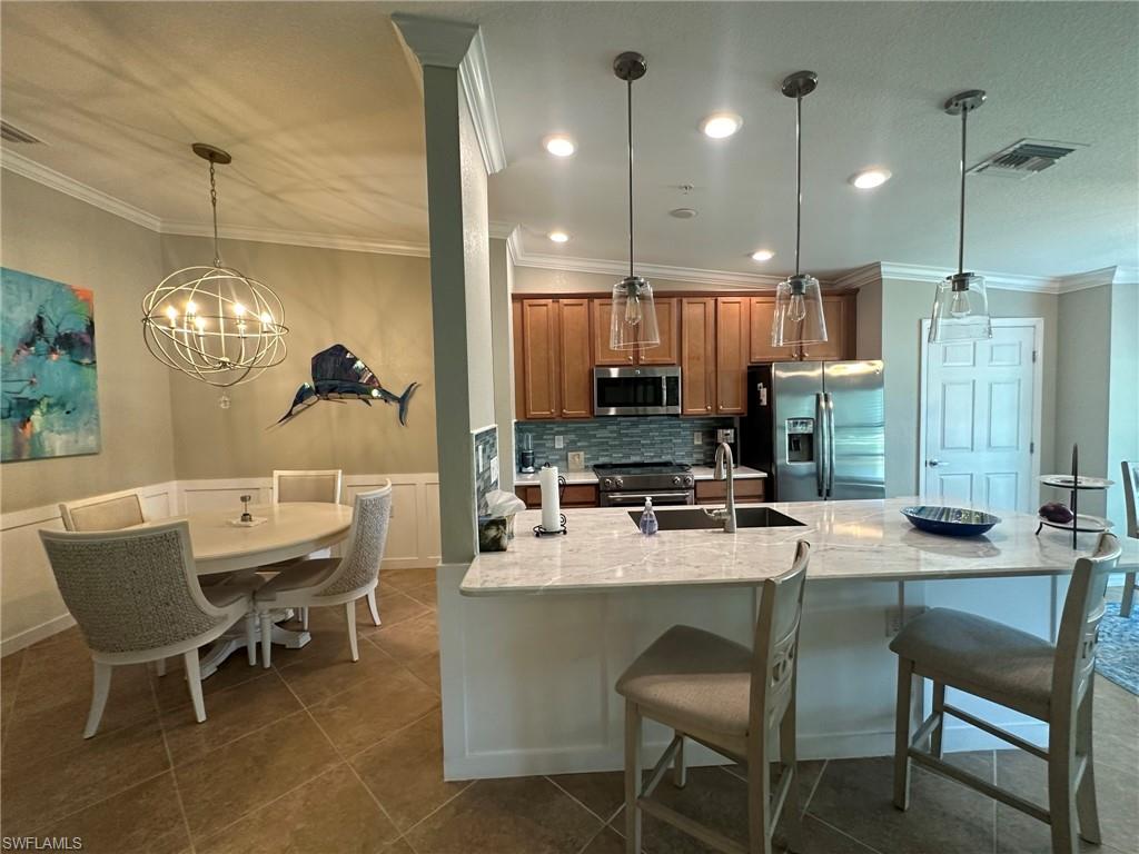 a kitchen with a dining table chairs and microwave