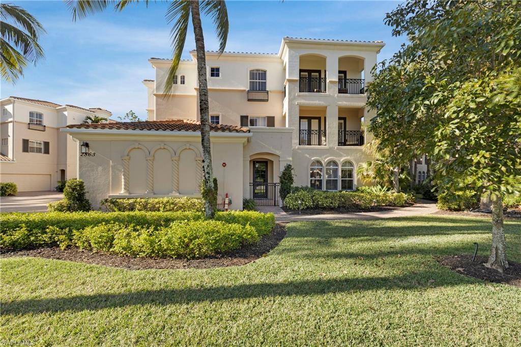 Mediterranean / spanish home featuring a balcony and a front lawn