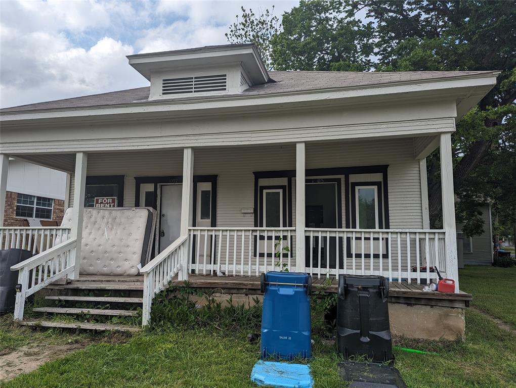 a view of a house with a porch and furniture