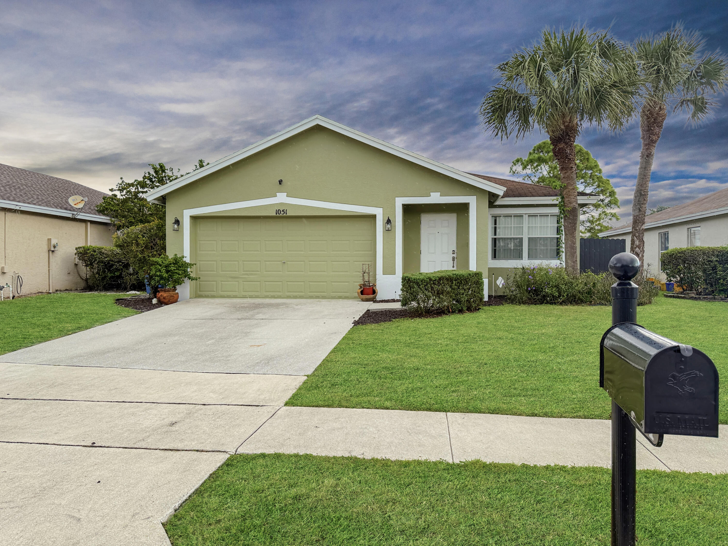 a front view of house with yard and green space