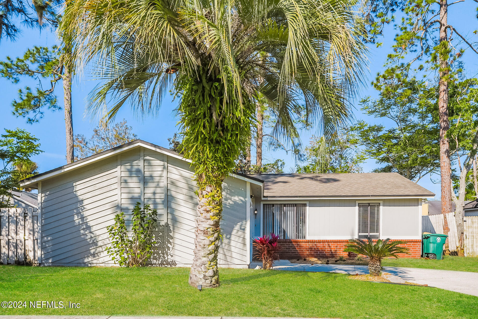 a front view of house with yard and outdoor seating