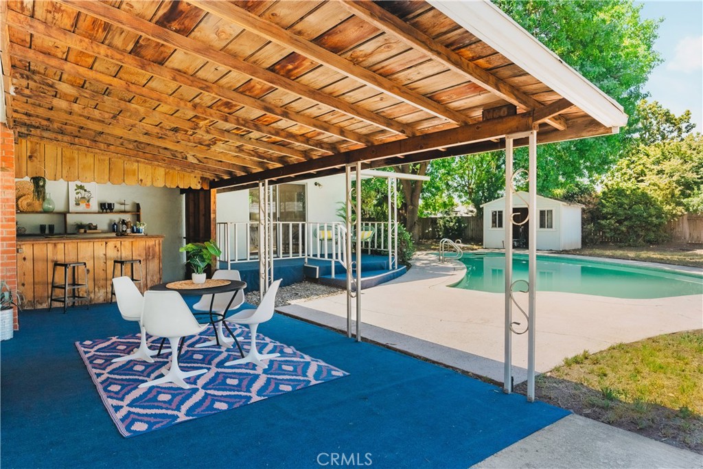 a patio view with a table and chairs