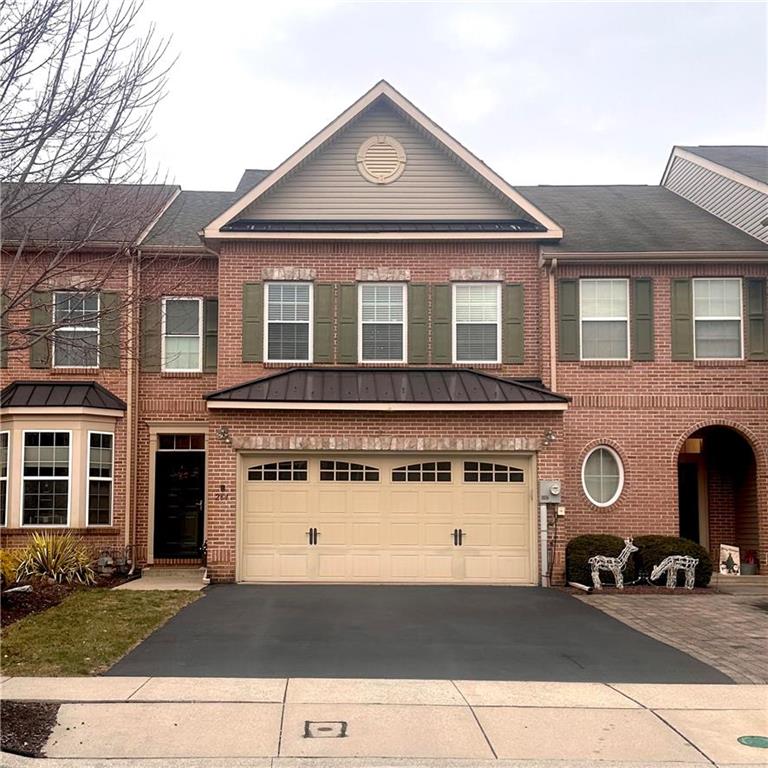 a front view of a house with parking space