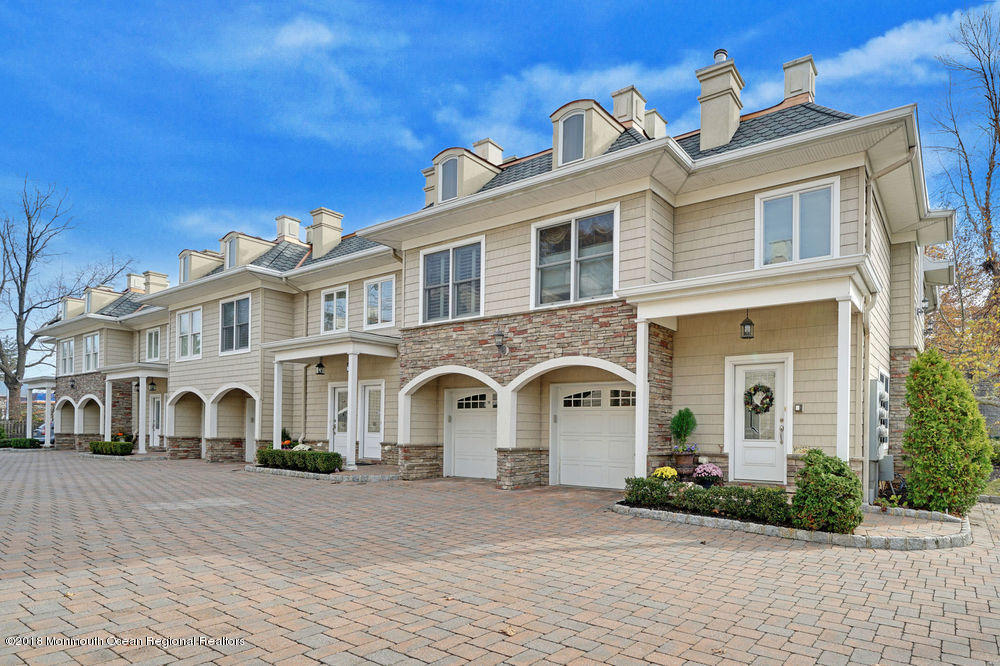 a front view of a residential houses with yard