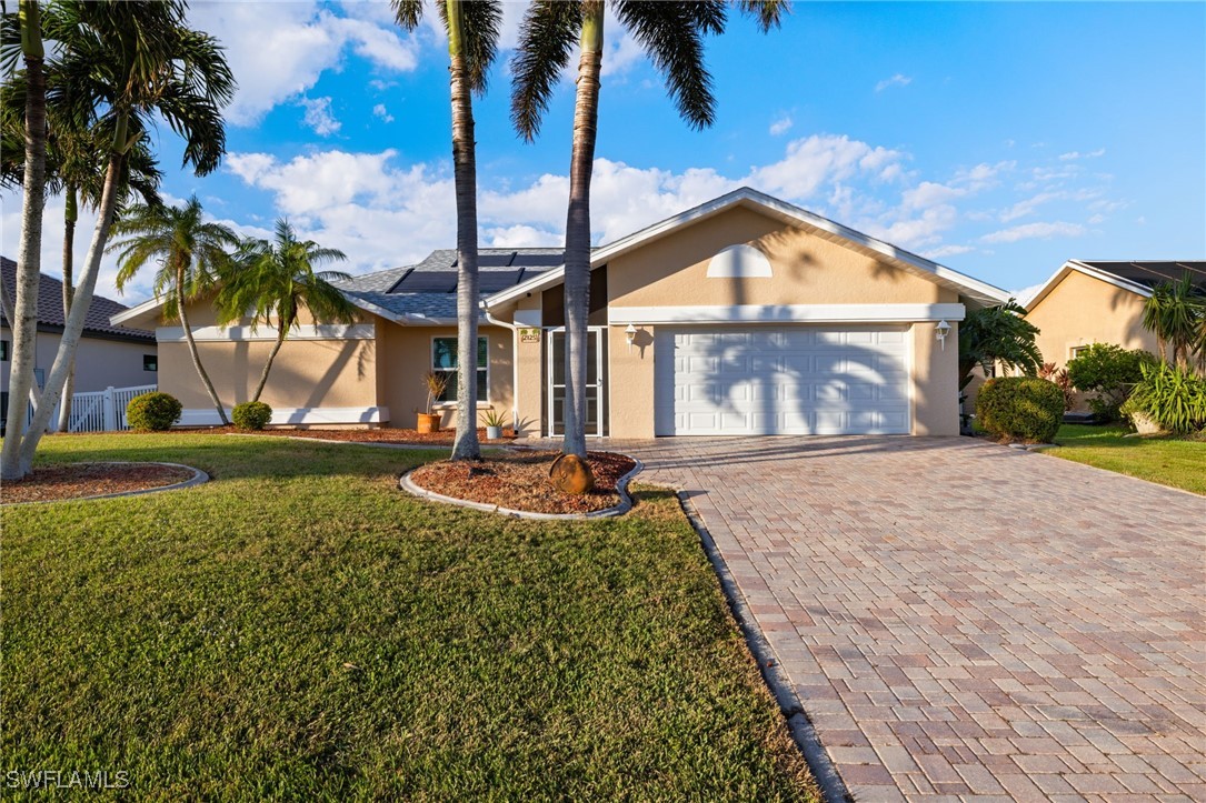 a front view of a house with garden and patio