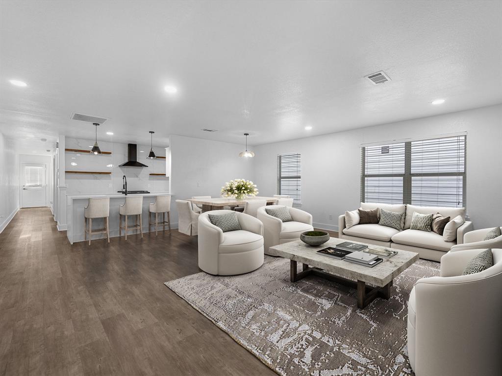 "Spacious and bright, this open concept living area features sleek wood-look flooring and recessed lighting, perfect for both relaxing and entertaining.