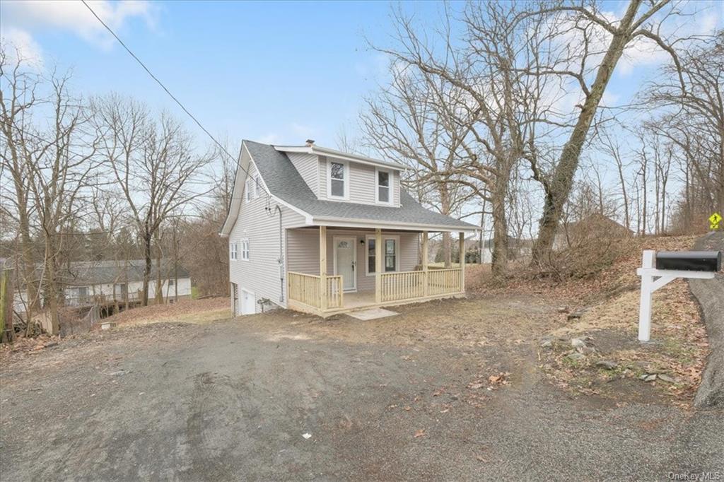 a view of house with a yard