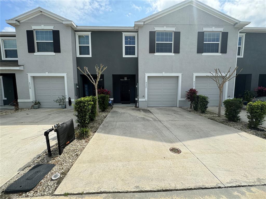 a front view of a house with yard