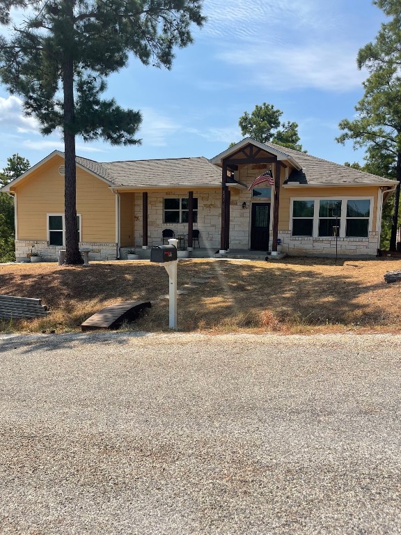 a front view of a house with a garden and yard