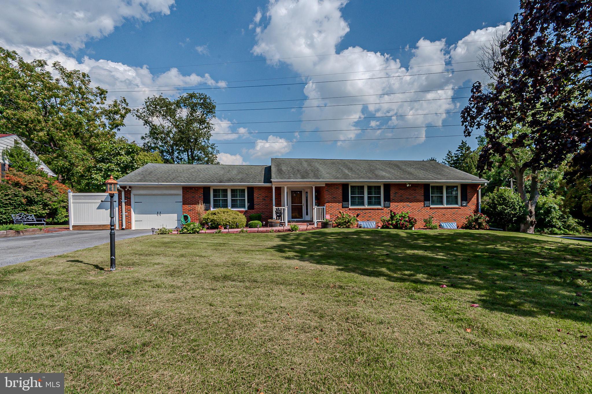 Brick ranch with large yard and one-car garage