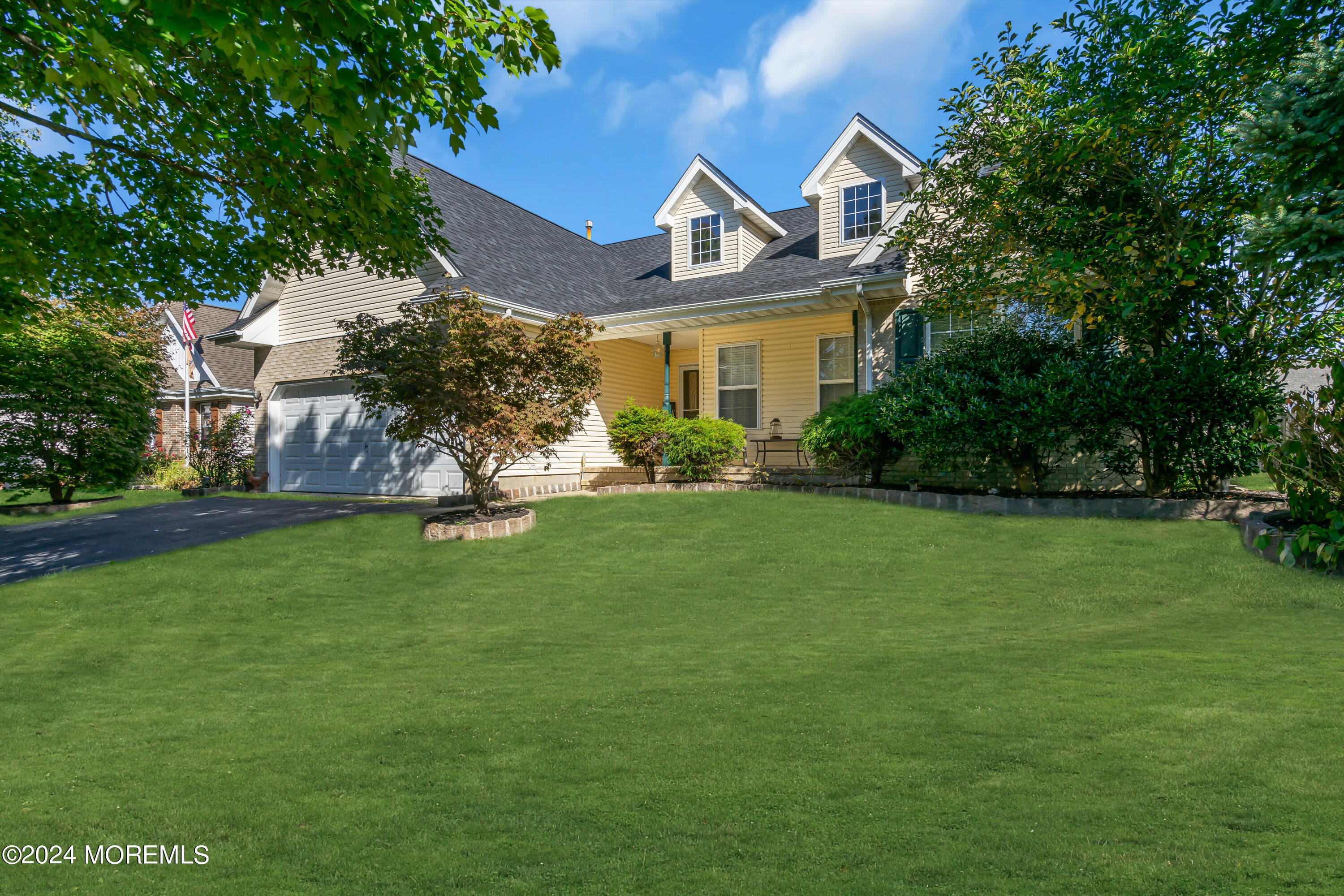 a front view of house with yard and green space