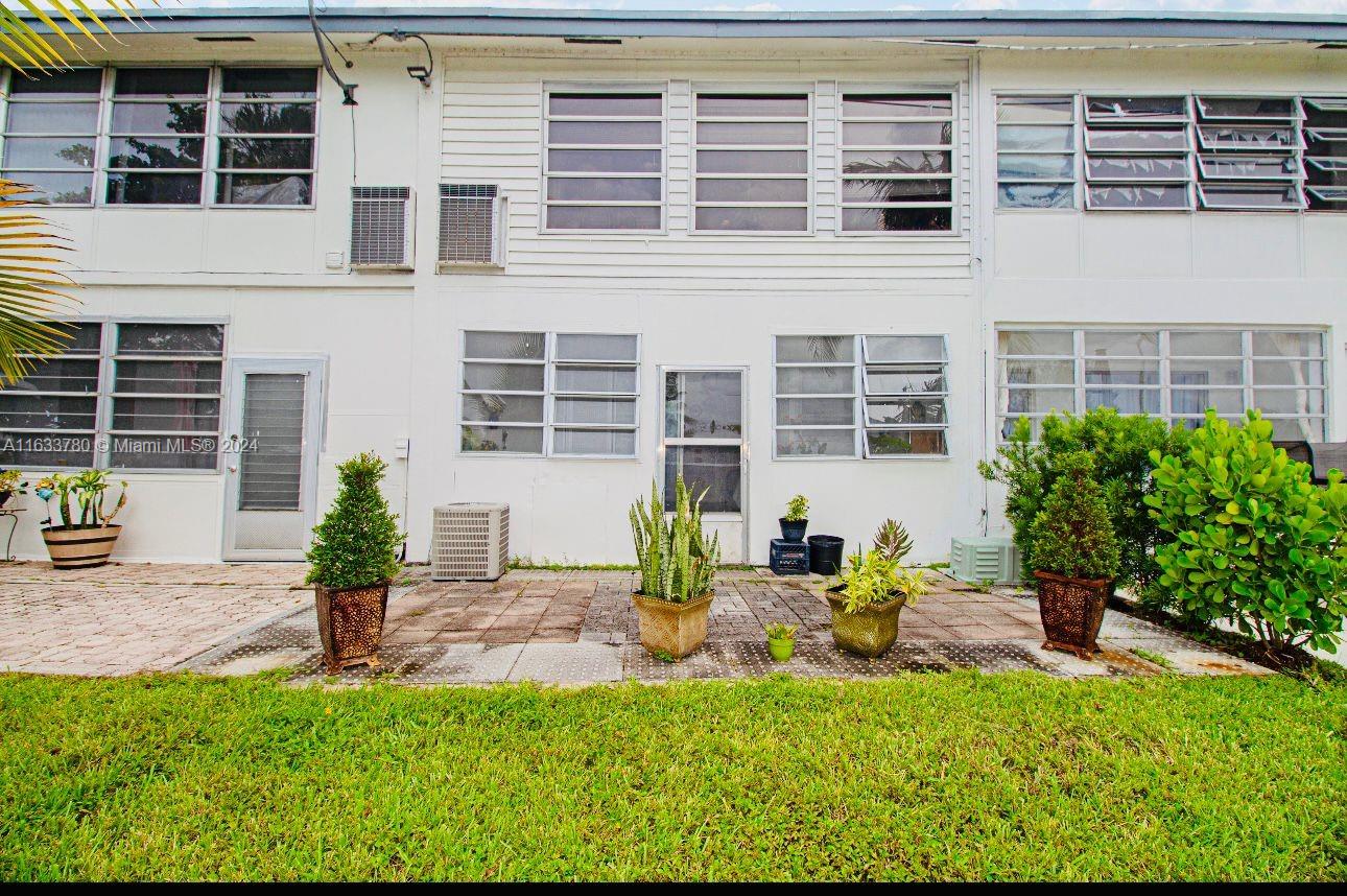 a view of a house with backyard sitting area and garden