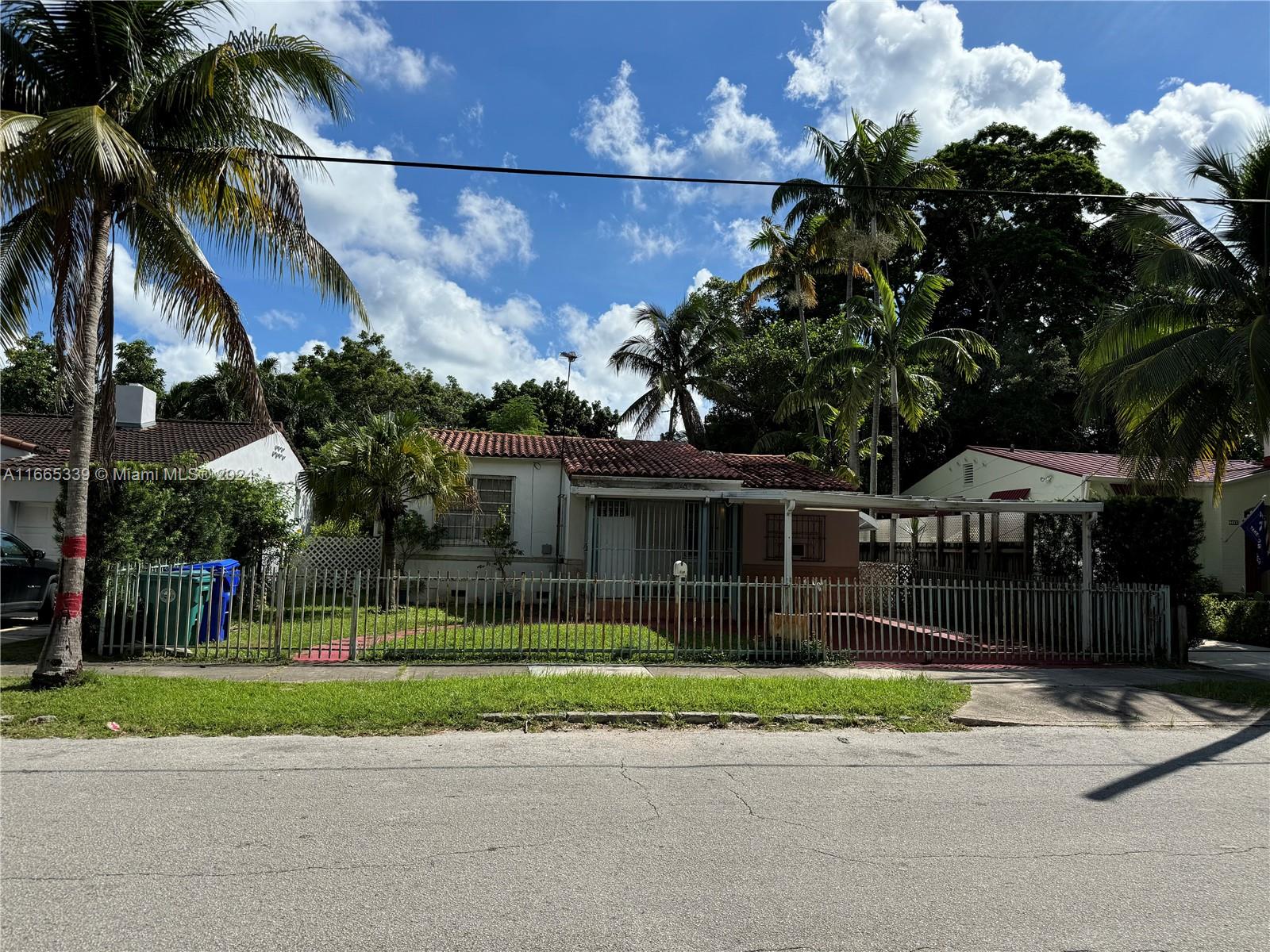 a view of a house with a yard and a garden