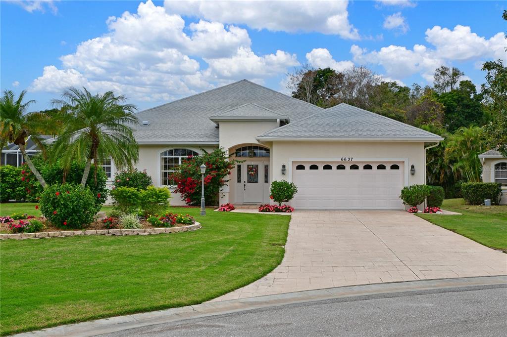 a front view of a house with a yard and garage