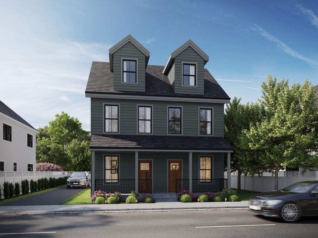 a front view of a house with garage and parking