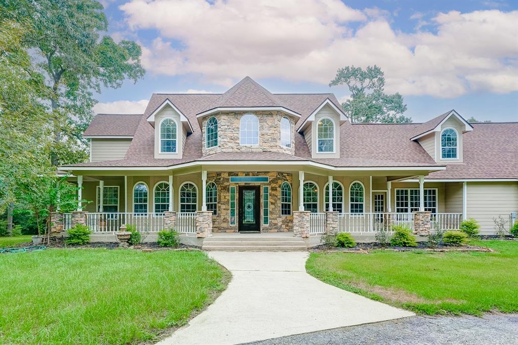 front view of a brick house with a yard