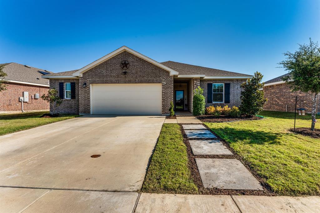 a front view of a house with yard