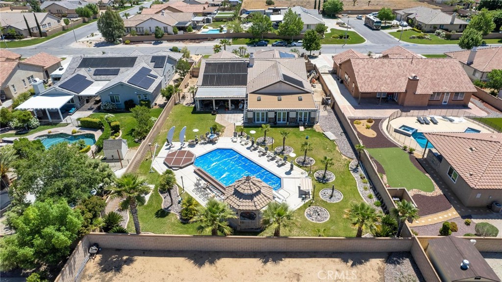 an aerial view of residential house with outdoor space and swimming pool