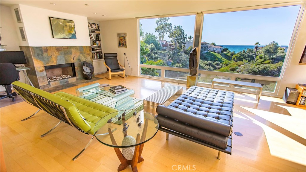 a living room with furniture and a open kitchen view