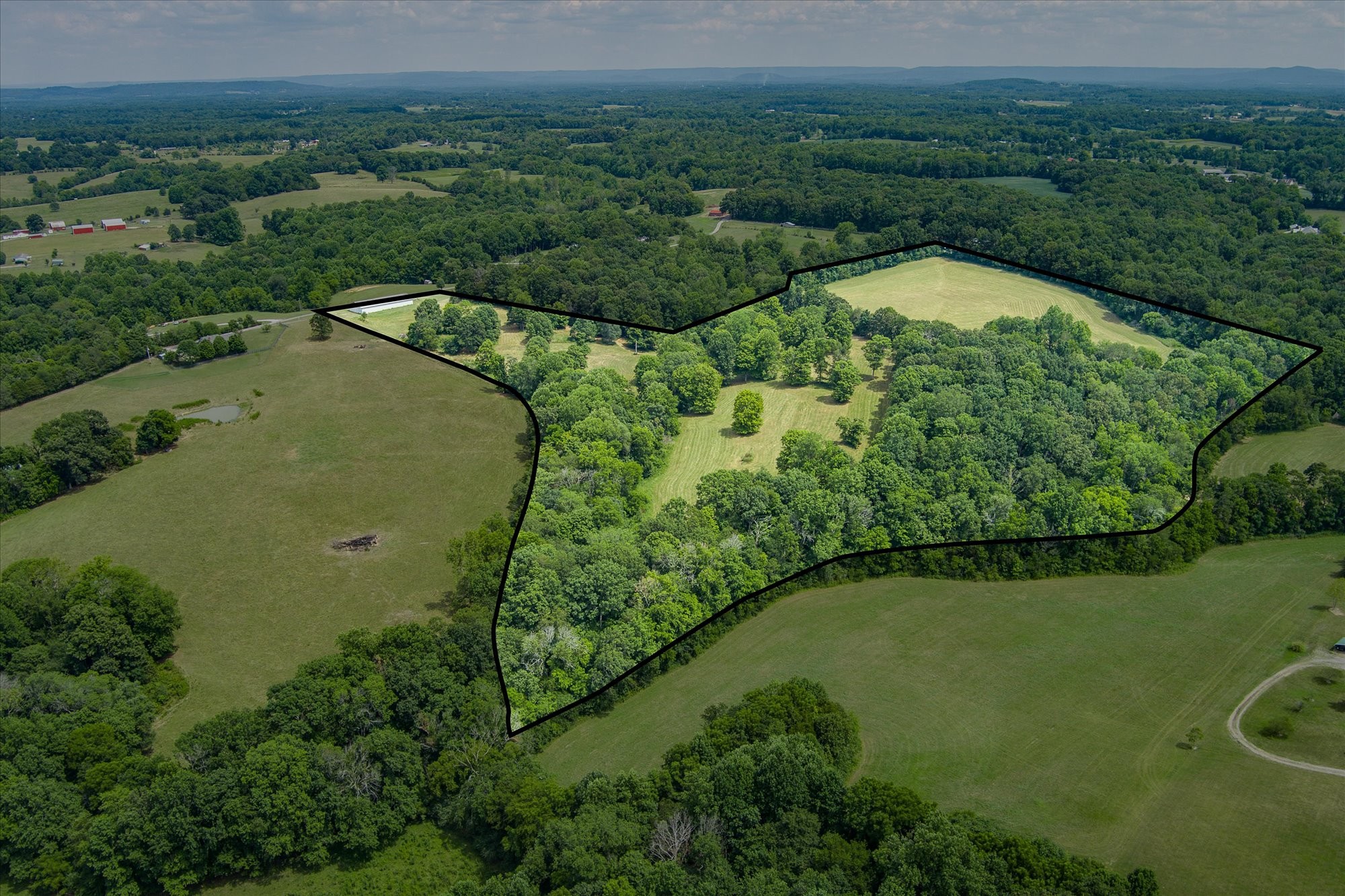 an aerial view of a houses with a yard