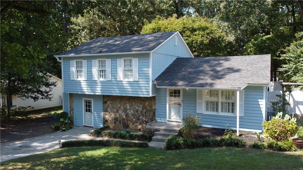 a front view of a house with a yard and outdoor seating