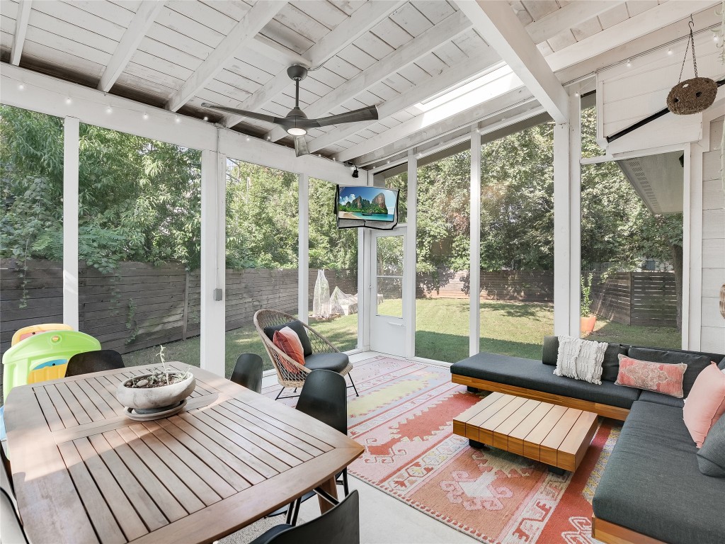 a living room with furniture and floor to ceiling windows