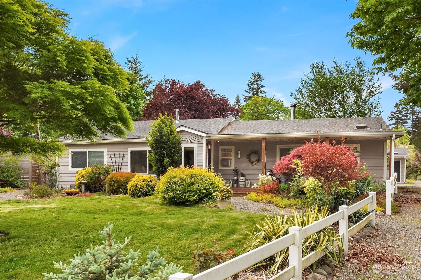 a front view of house with yard and green space