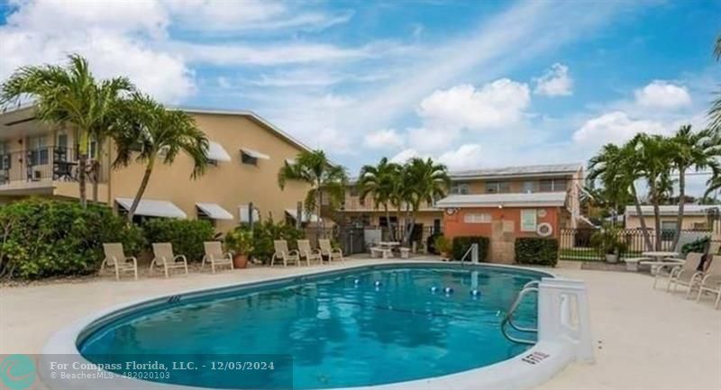 a swimming pool with outdoor seating and yard