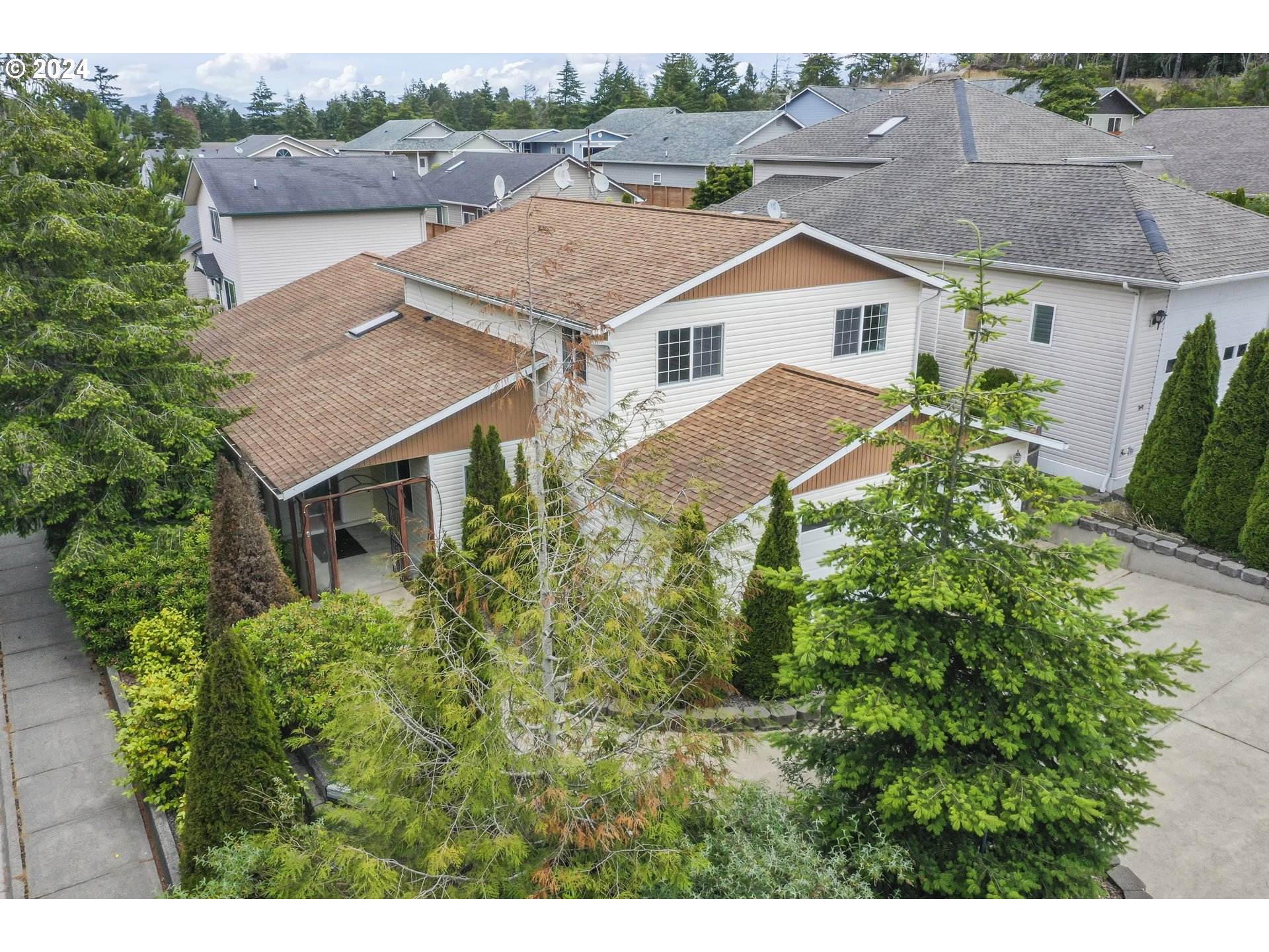 a aerial view of a house with a yard and plants