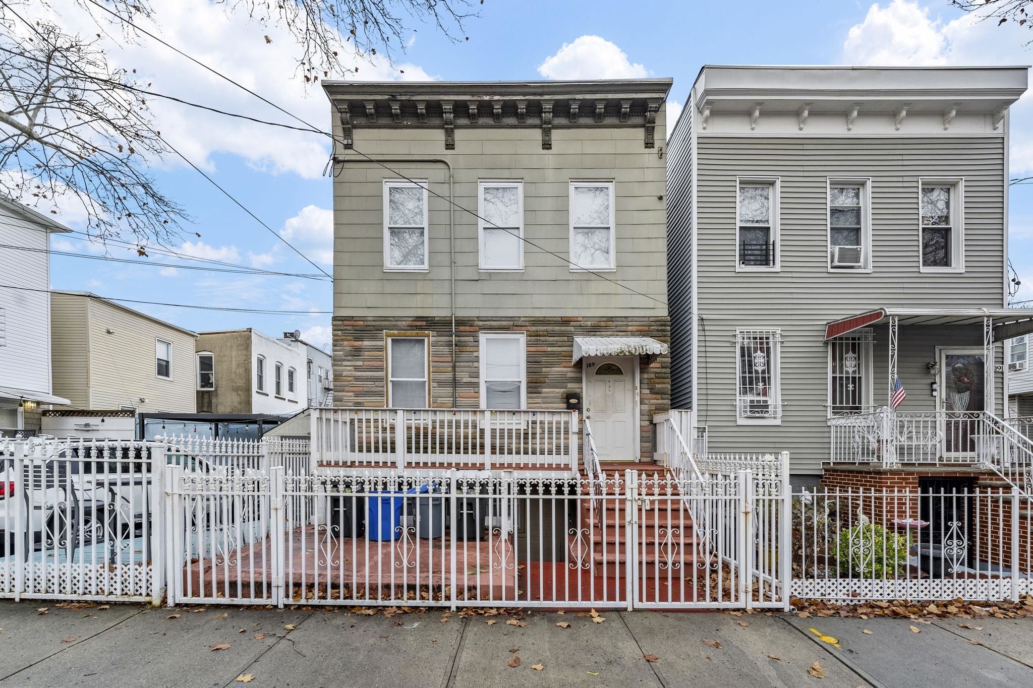 a front view of a house with a fence