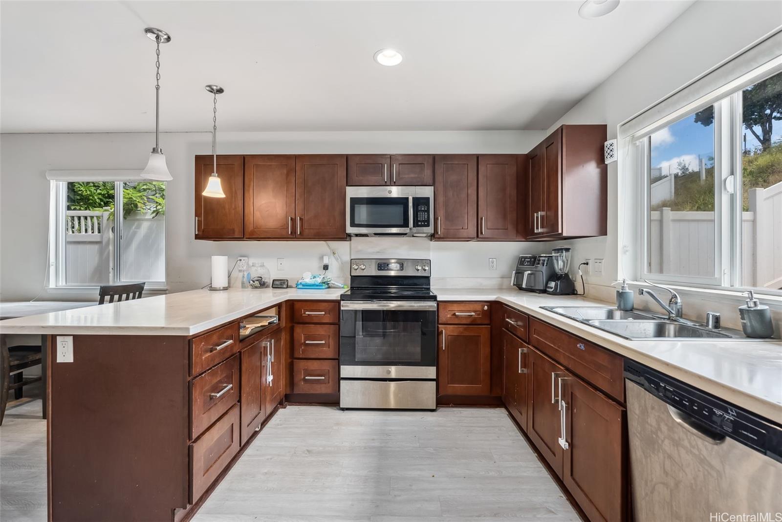 a kitchen with stainless steel appliances granite countertop a sink and stove top oven