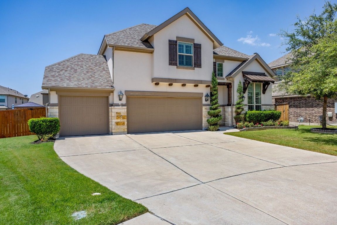 a front view of a house with a yard and garage