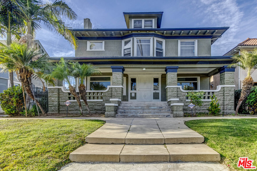 a front view of a house with fountain