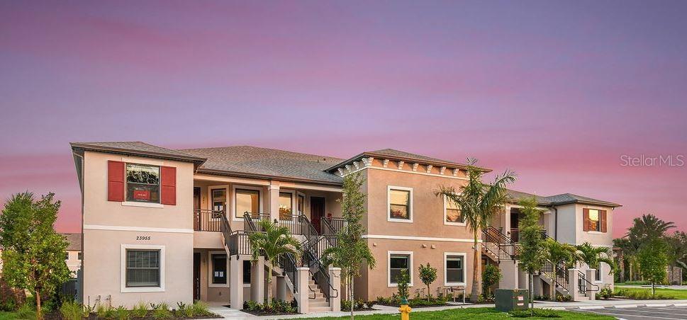 a front view of multi story residential apartment building with yard