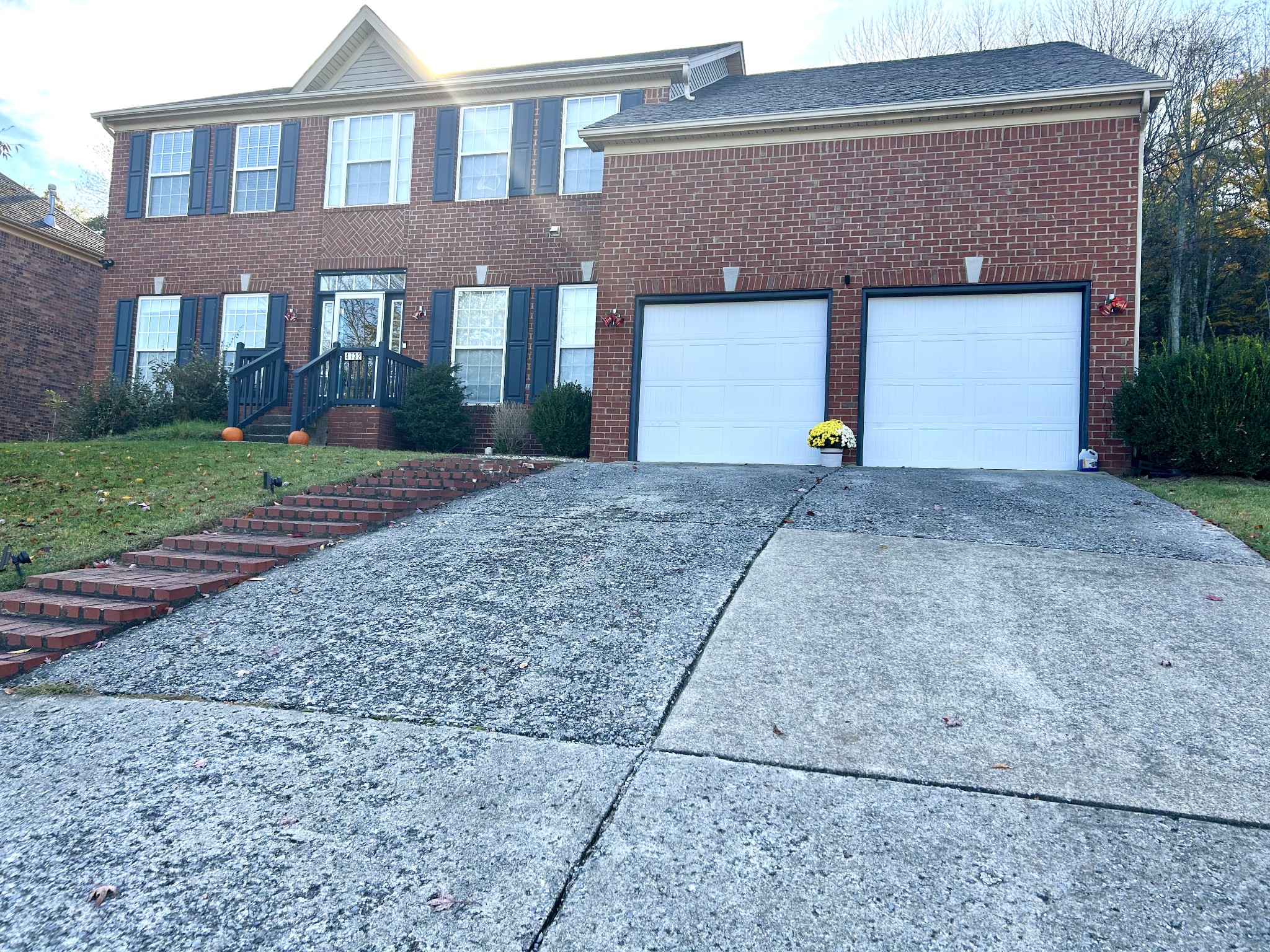 a front view of a house with a yard and a garage