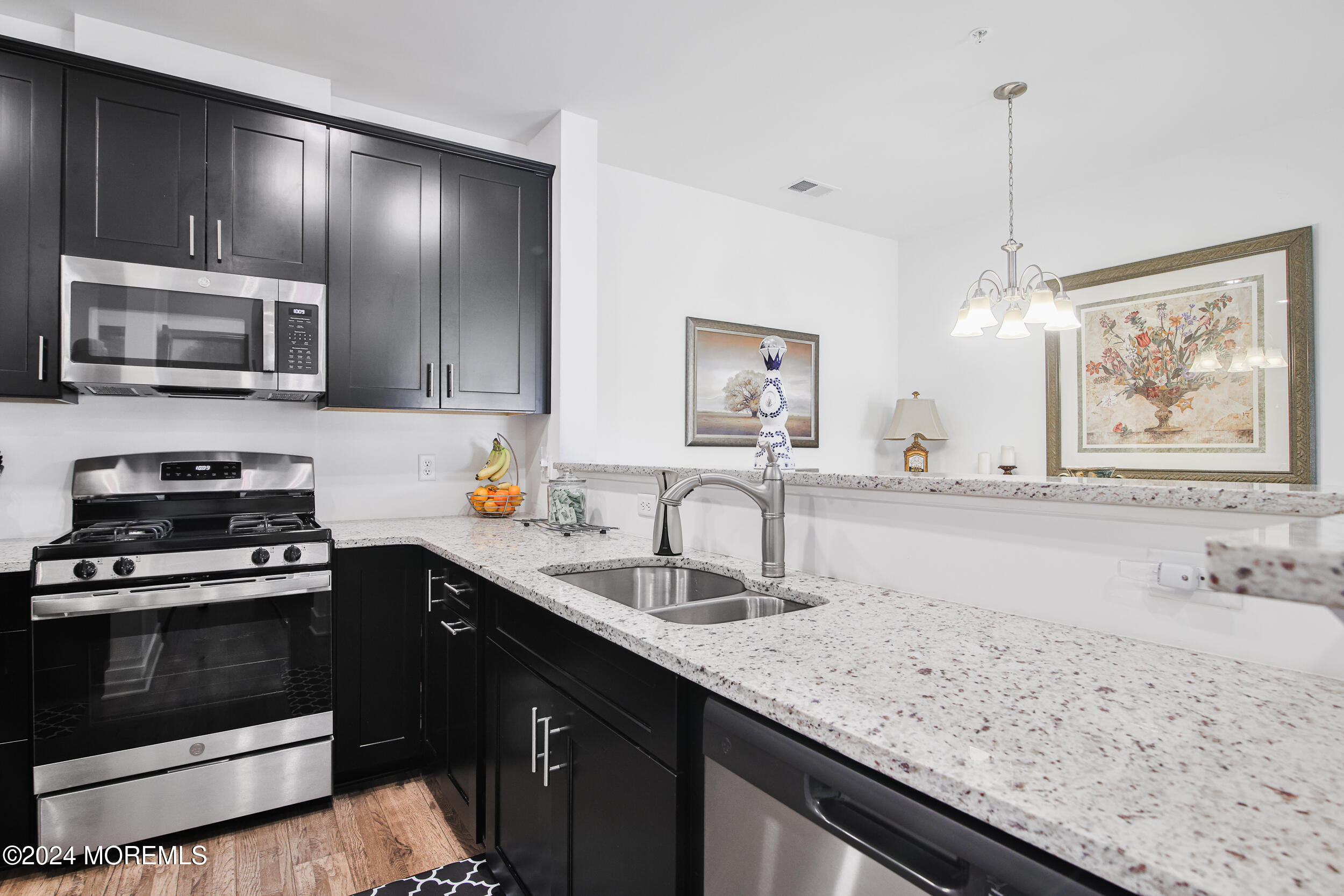 a kitchen with a stove sink and microwave