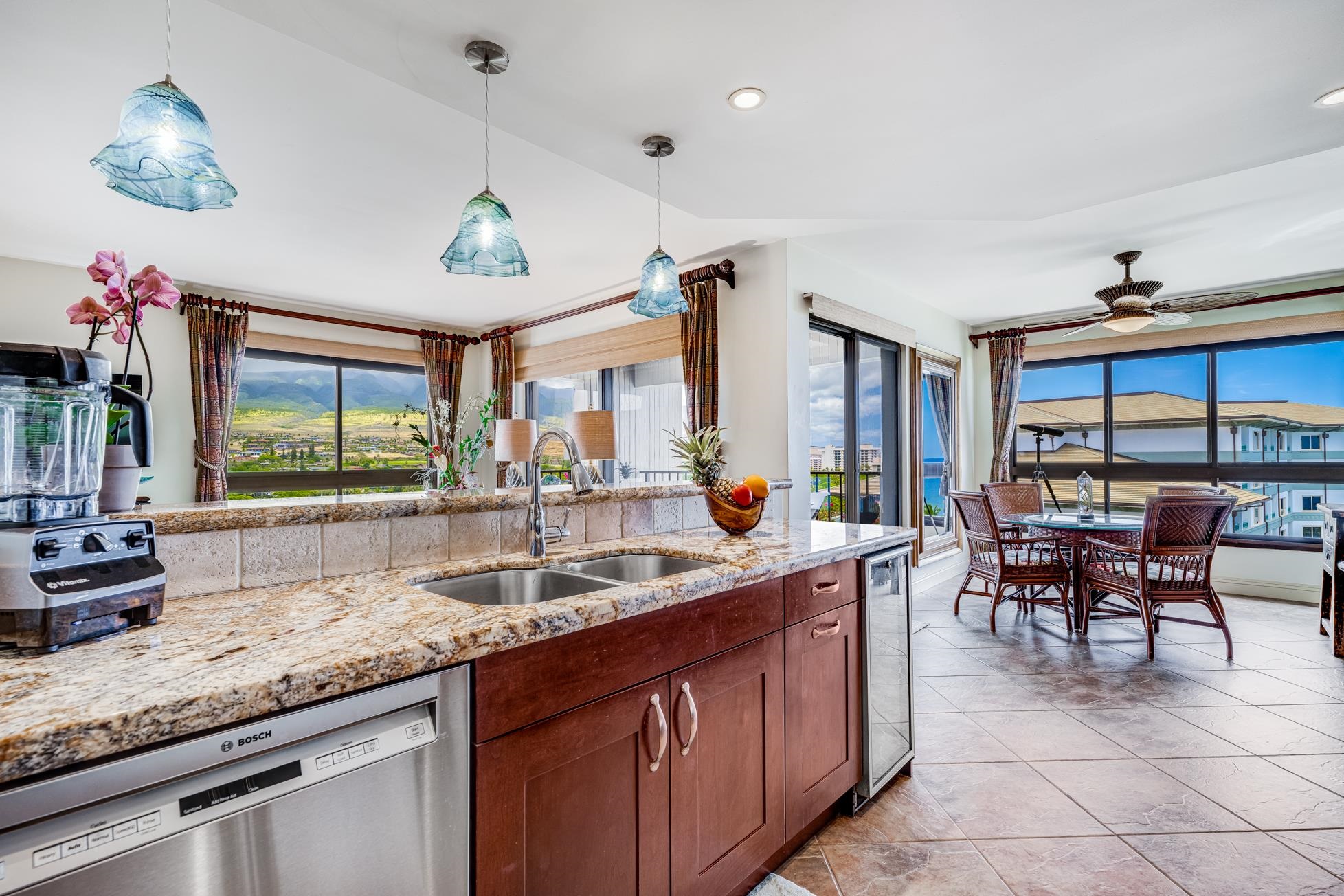 a very nice looking kitchen with granite countertop a large window and a counter space