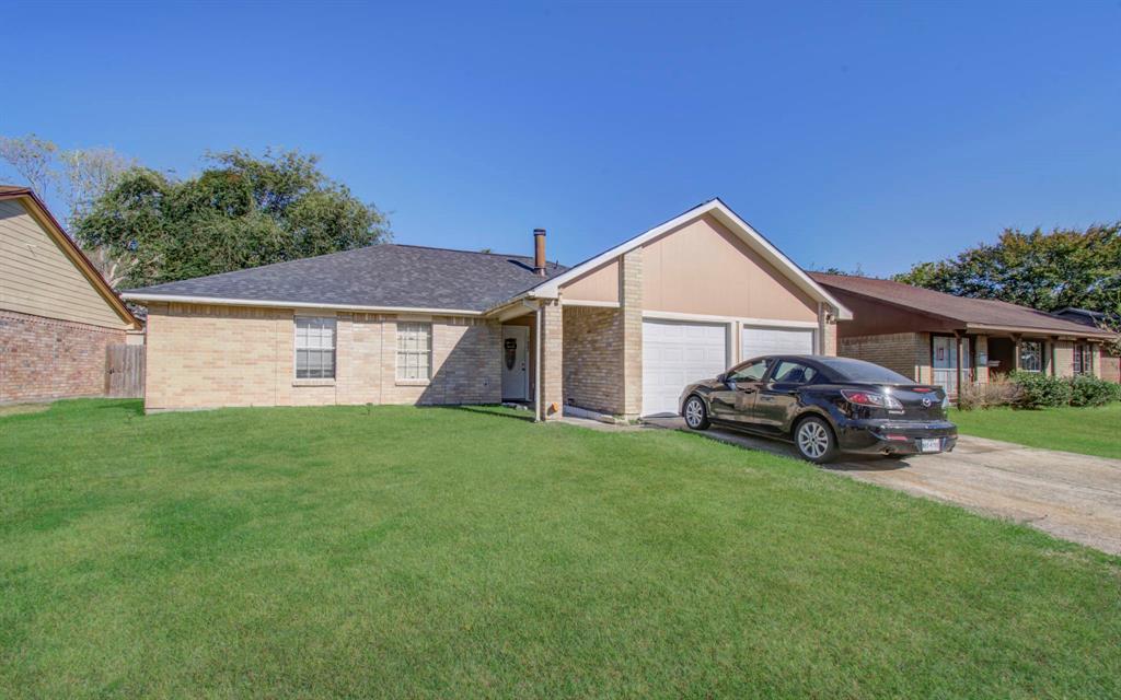 a view of a house with a yard and sitting area