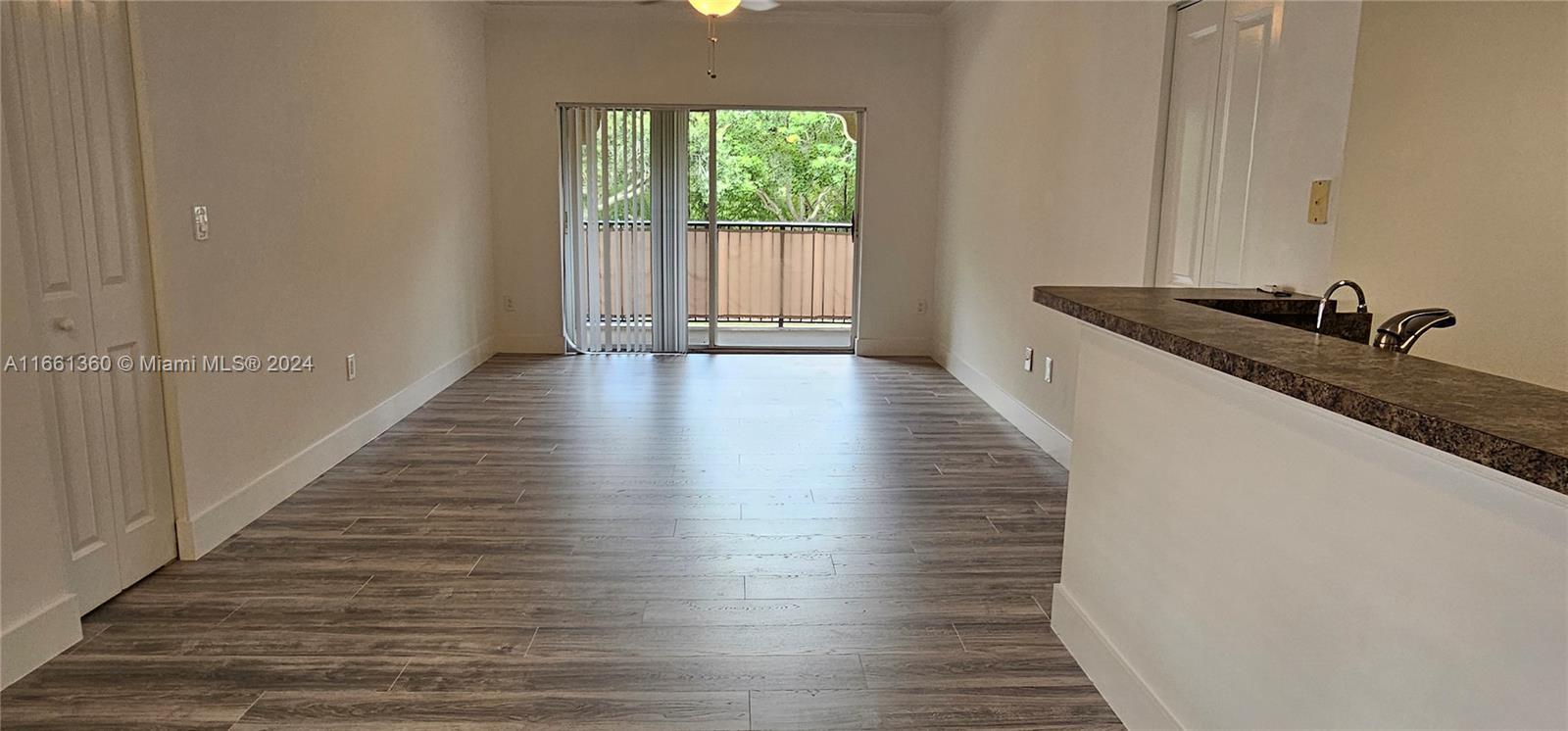 a hallway with wooden floor and front door