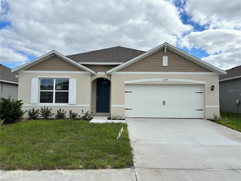 a front view of a house with a yard and garage