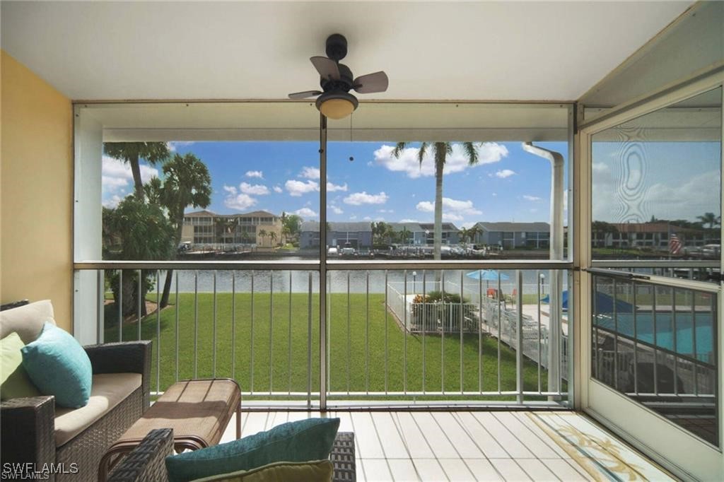 a view of a balcony with floor to ceiling windows with wooden floor