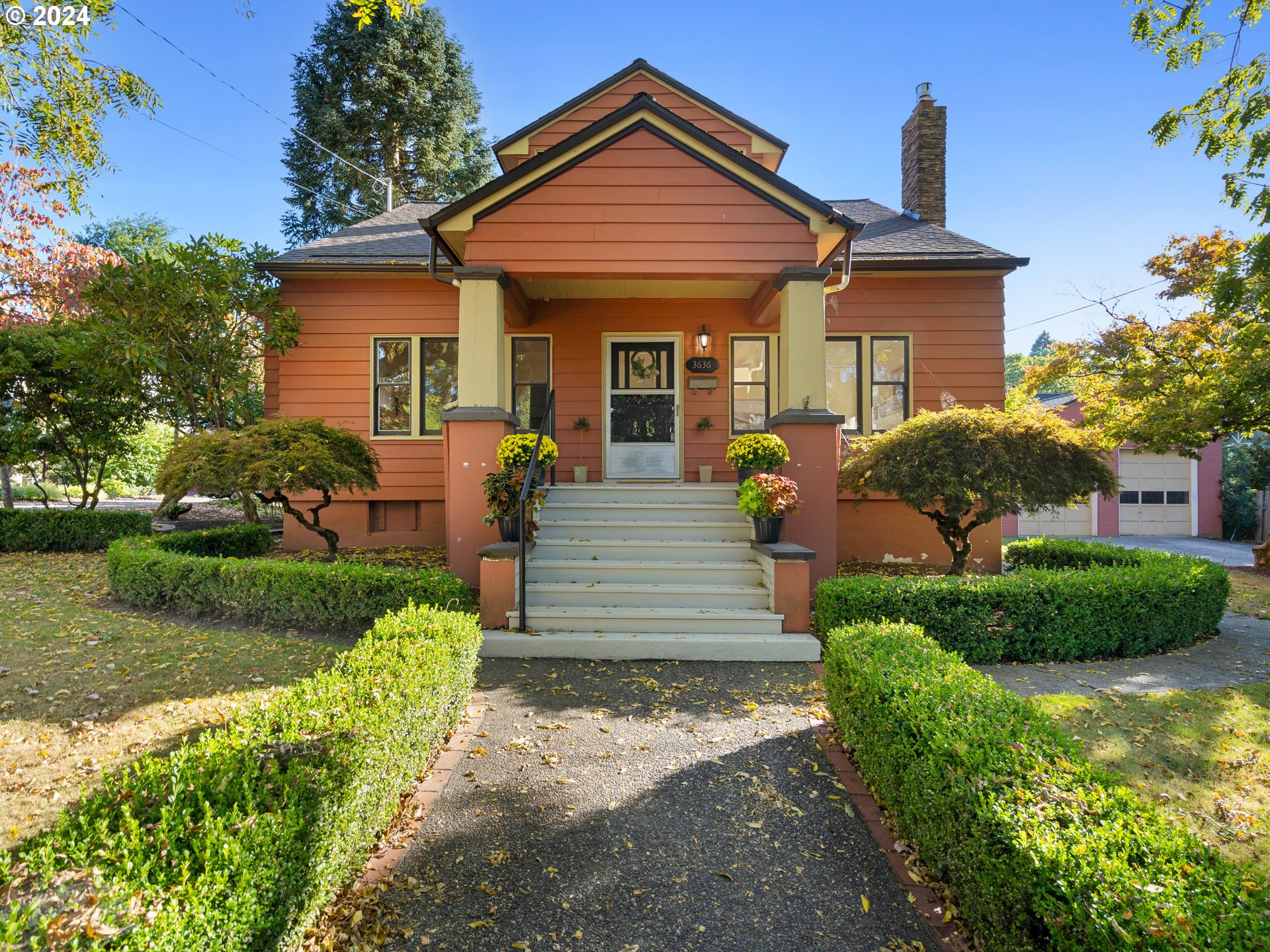 a front view of a house with garden