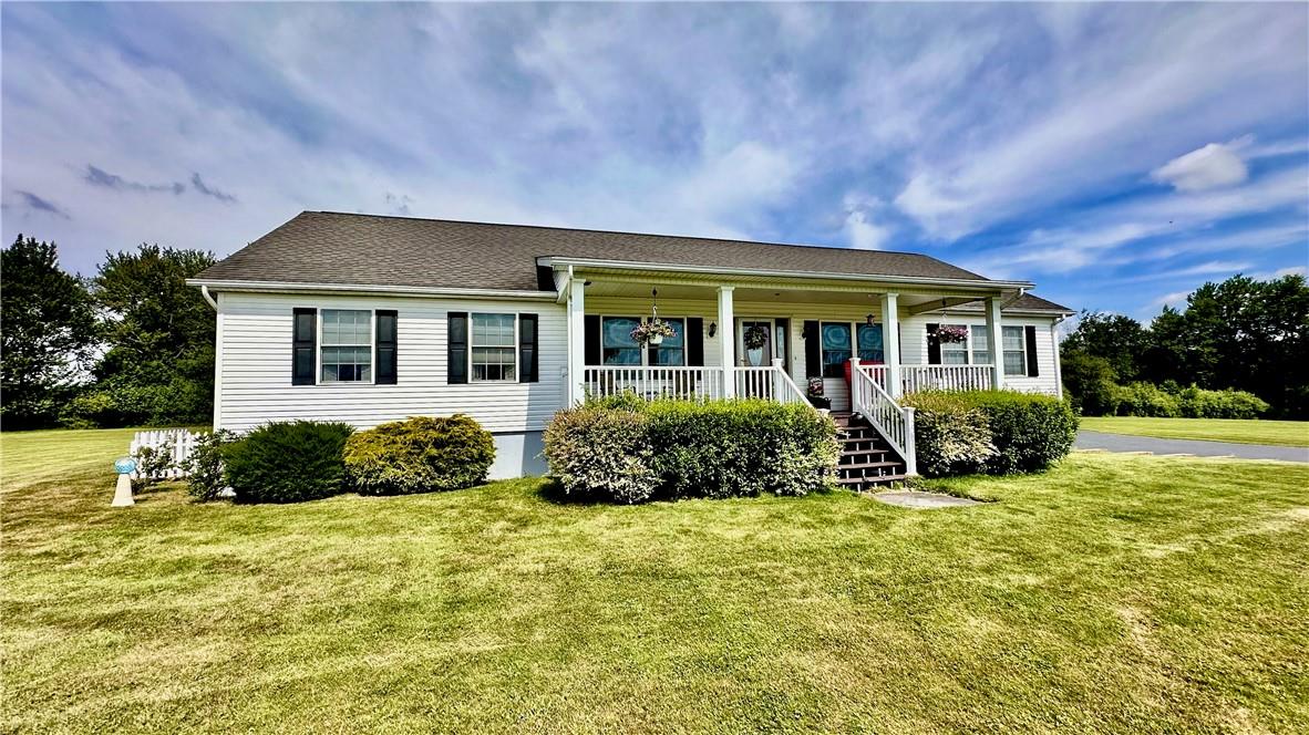 View of front facade with a front yard and covered porch