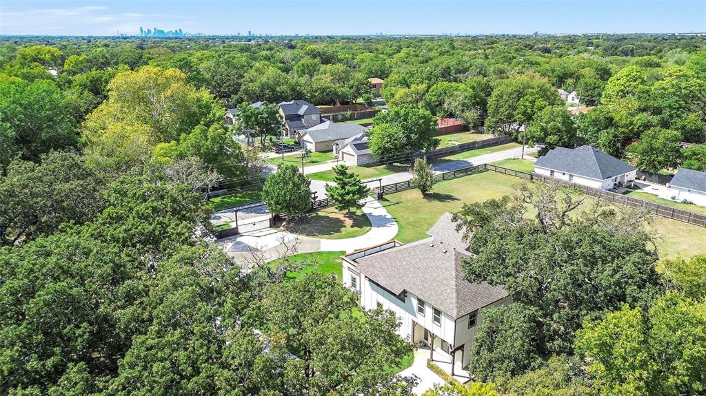 an aerial view of residential house with outdoor space and trees all around